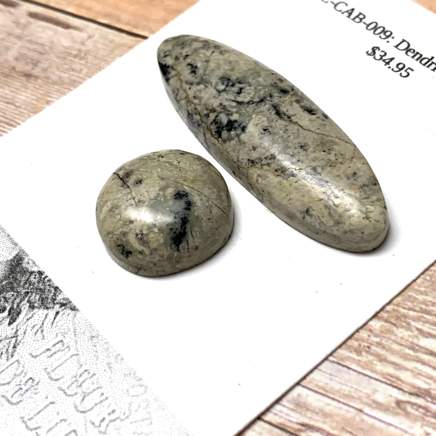DENDRITIC JASPER CABOCHON SET. SAND. BLACK. 40MM X 12MM OVAL 16MM ROUND.